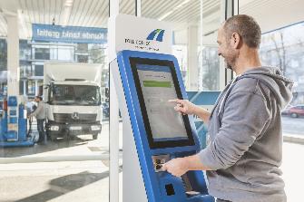 
A truck driver logging on at a toll terminal